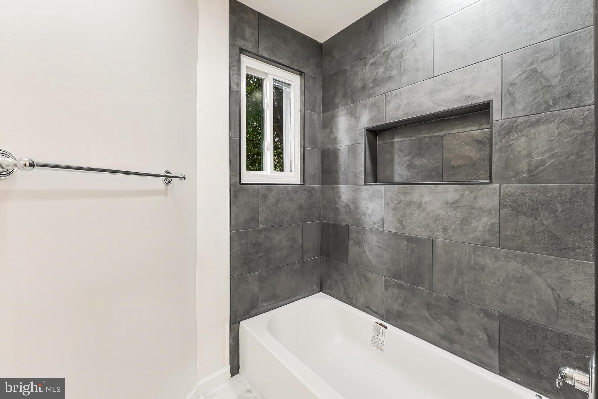 11916 Moss Point Lane Reston, VA 20194 - Photo 11 of 43 a bathroom with a bathtub and shower