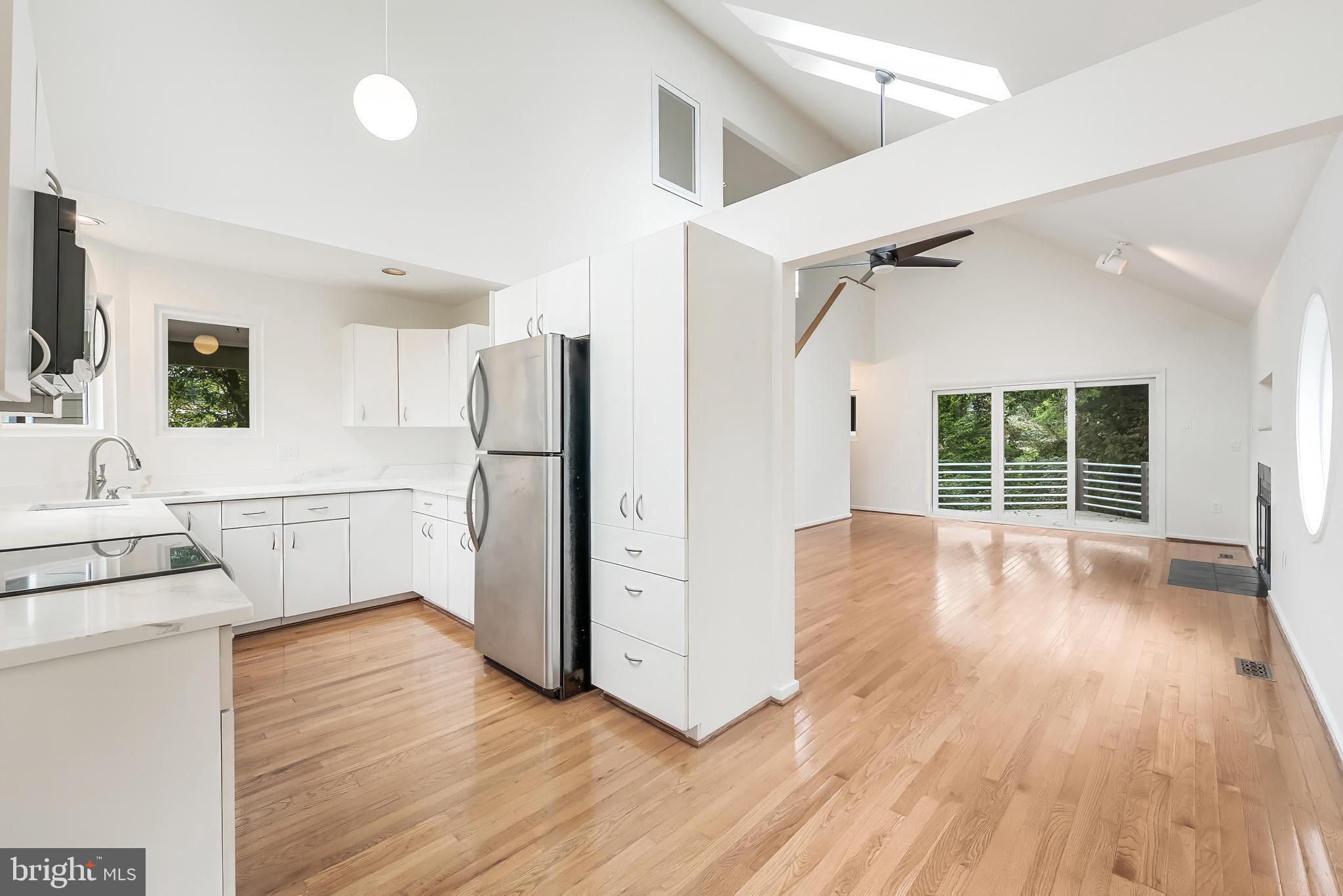 11916 Moss Point Lane Reston, VA 20194 - Photo 20 of 43 a view of a kitchen with wooden floor and a refrigerator
