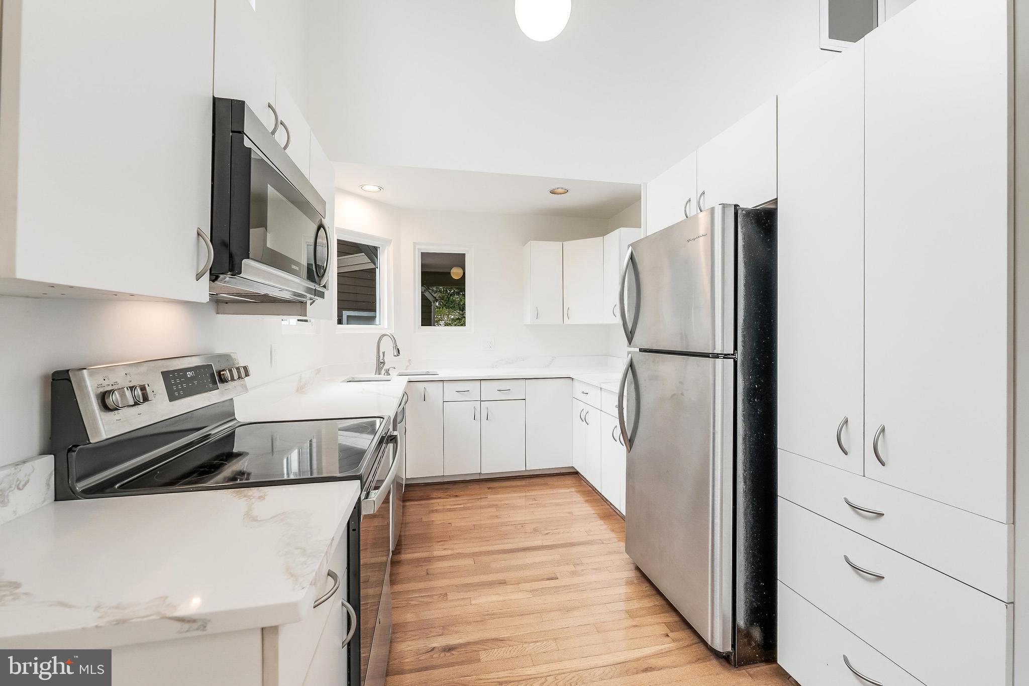 11916 Moss Point Lane Reston, VA 20194 - Photo 21 of 43 a kitchen with a refrigerator sink and stove top oven