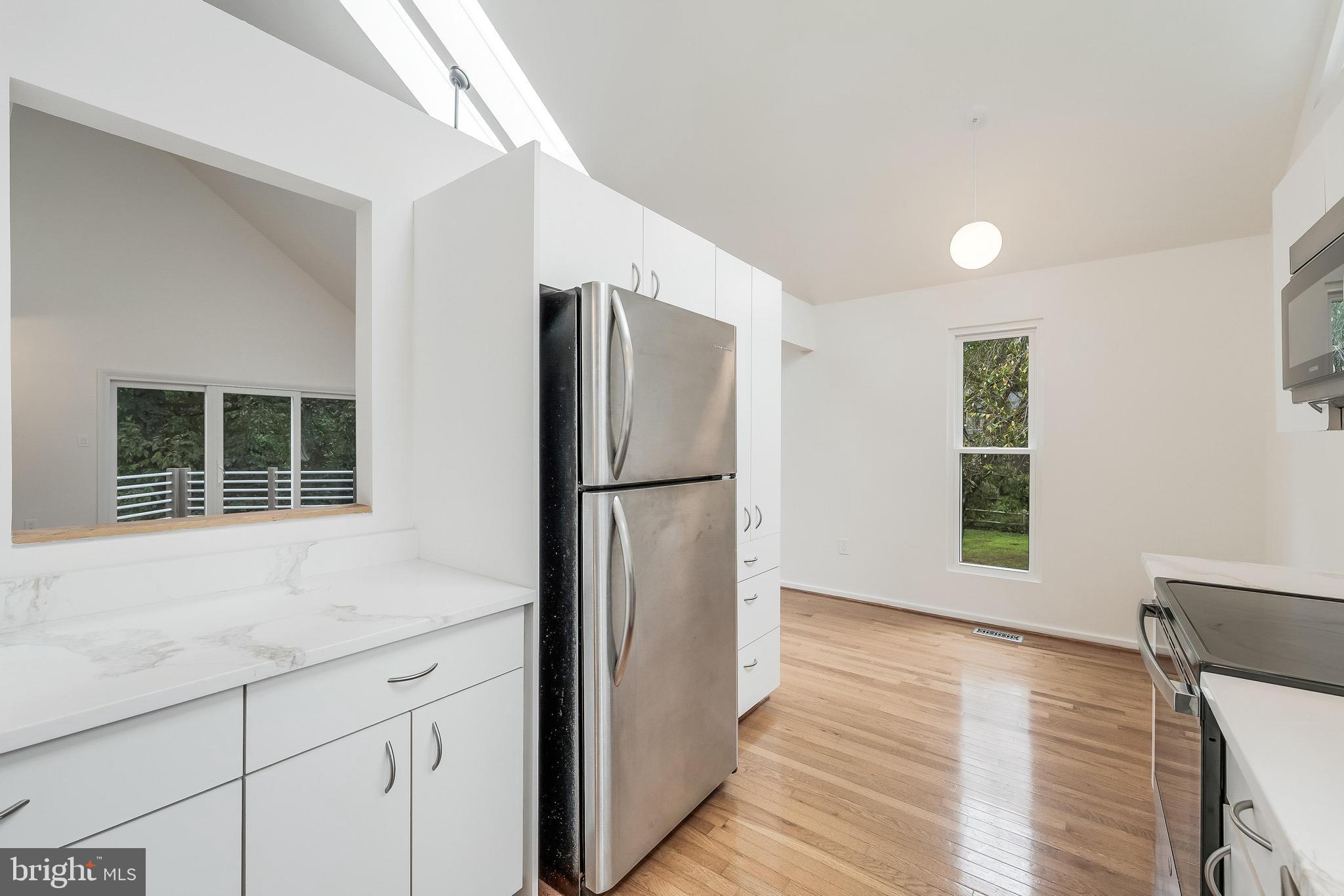 11916 Moss Point Lane Reston, VA 20194 - Photo 25 of 43 a kitchen with a refrigerator and wooden floor