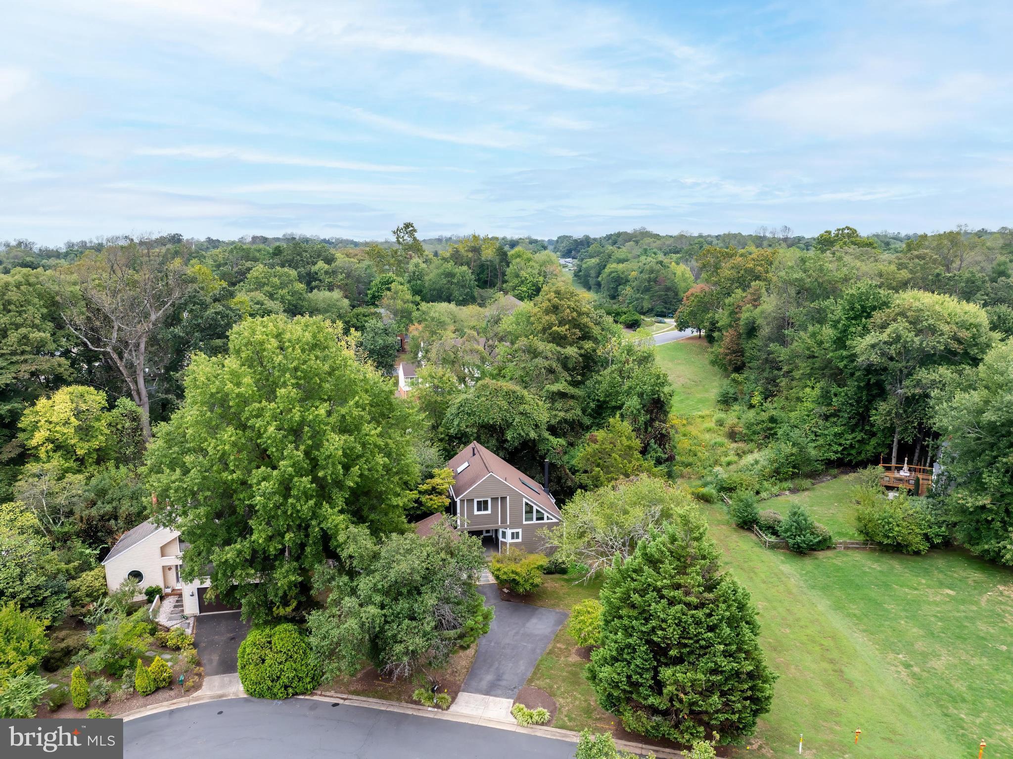 11916 Moss Point Lane Reston, VA 20194 - Photo 43 of 43 an aerial view of a city with lots of residential buildings and mountain view in back