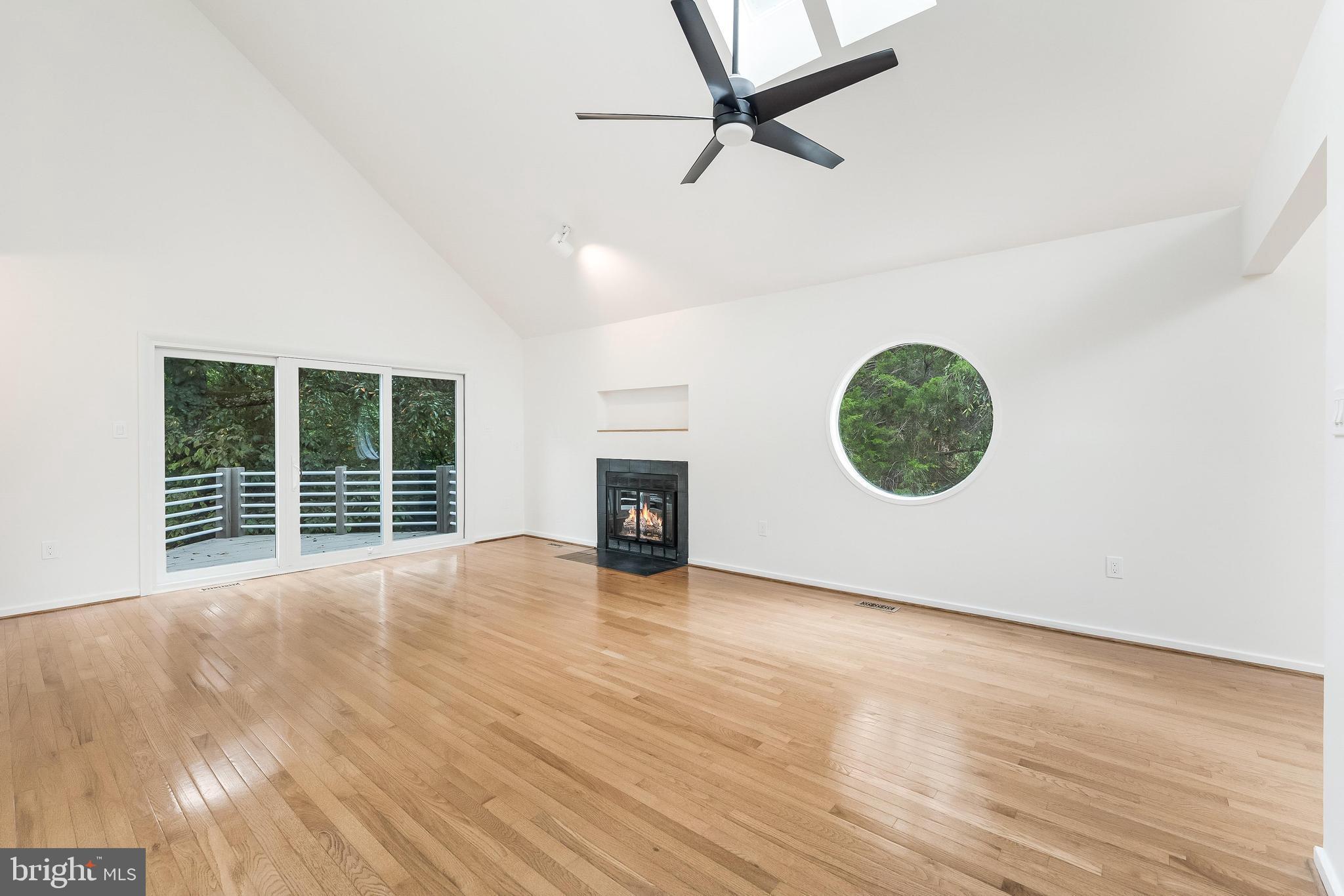 11916 Moss Point Lane Reston, VA 20194 - Photo 6 of 43 an empty room with wooden floor and windows