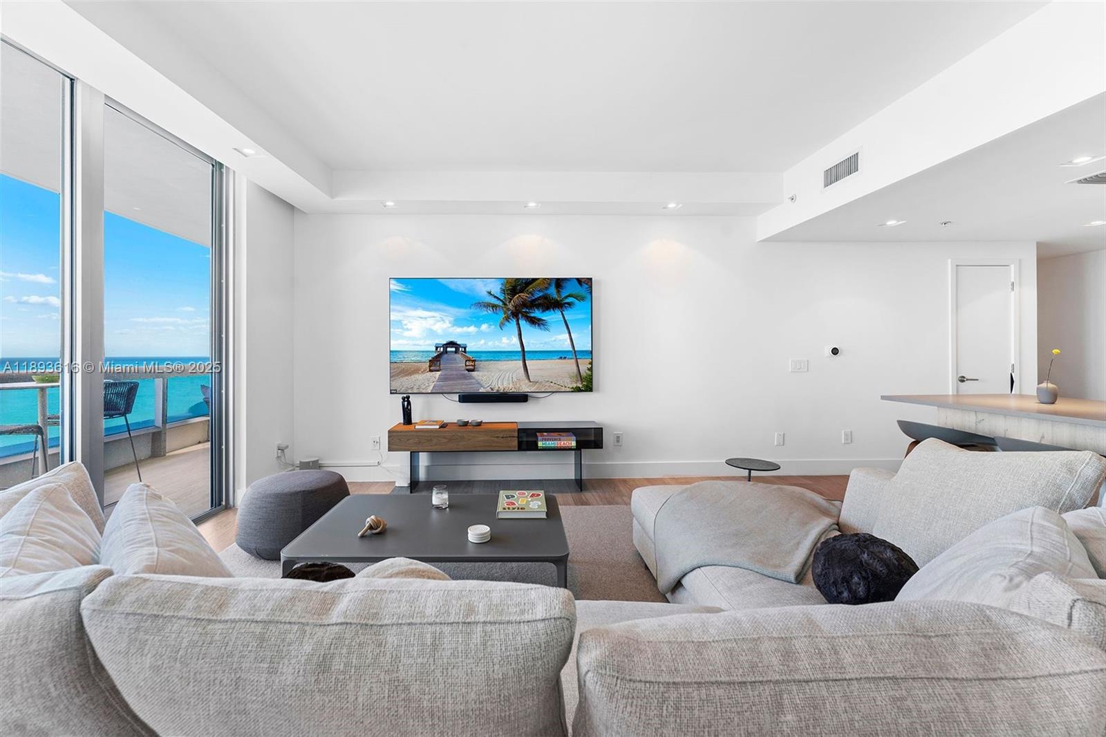 6899 Collins Avenue, Unit 2601 Miami Beach, FL 33141 - Photo 23 of 70 a living room with furniture and a wooden floor