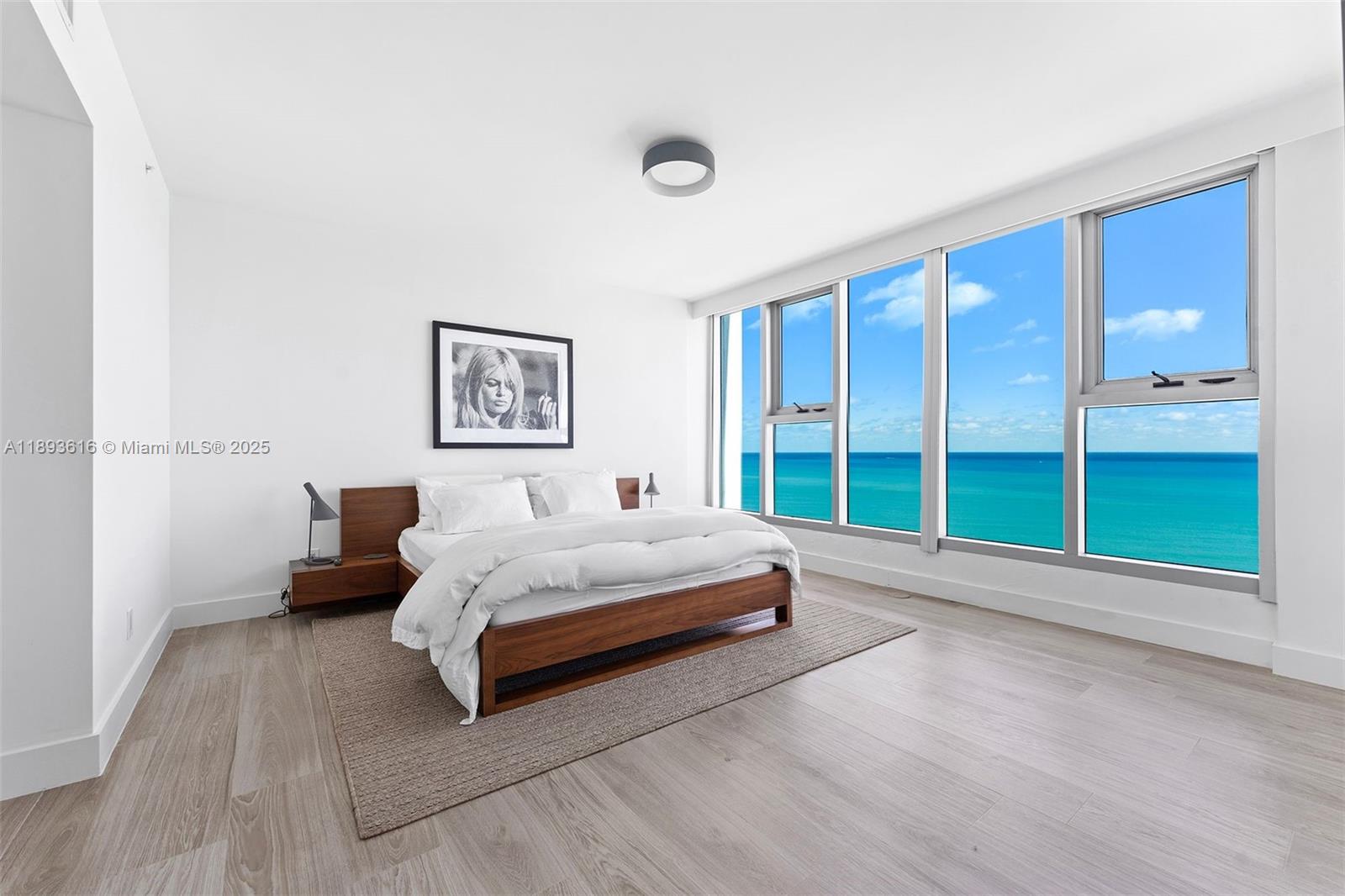 6899 Collins Avenue, Unit 2601 Miami Beach, FL 33141 - Photo 29 of 70 a spacious bedroom with a bed and a large window
