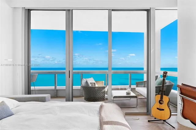 a living room with a flat screen tv and a floor to ceiling window