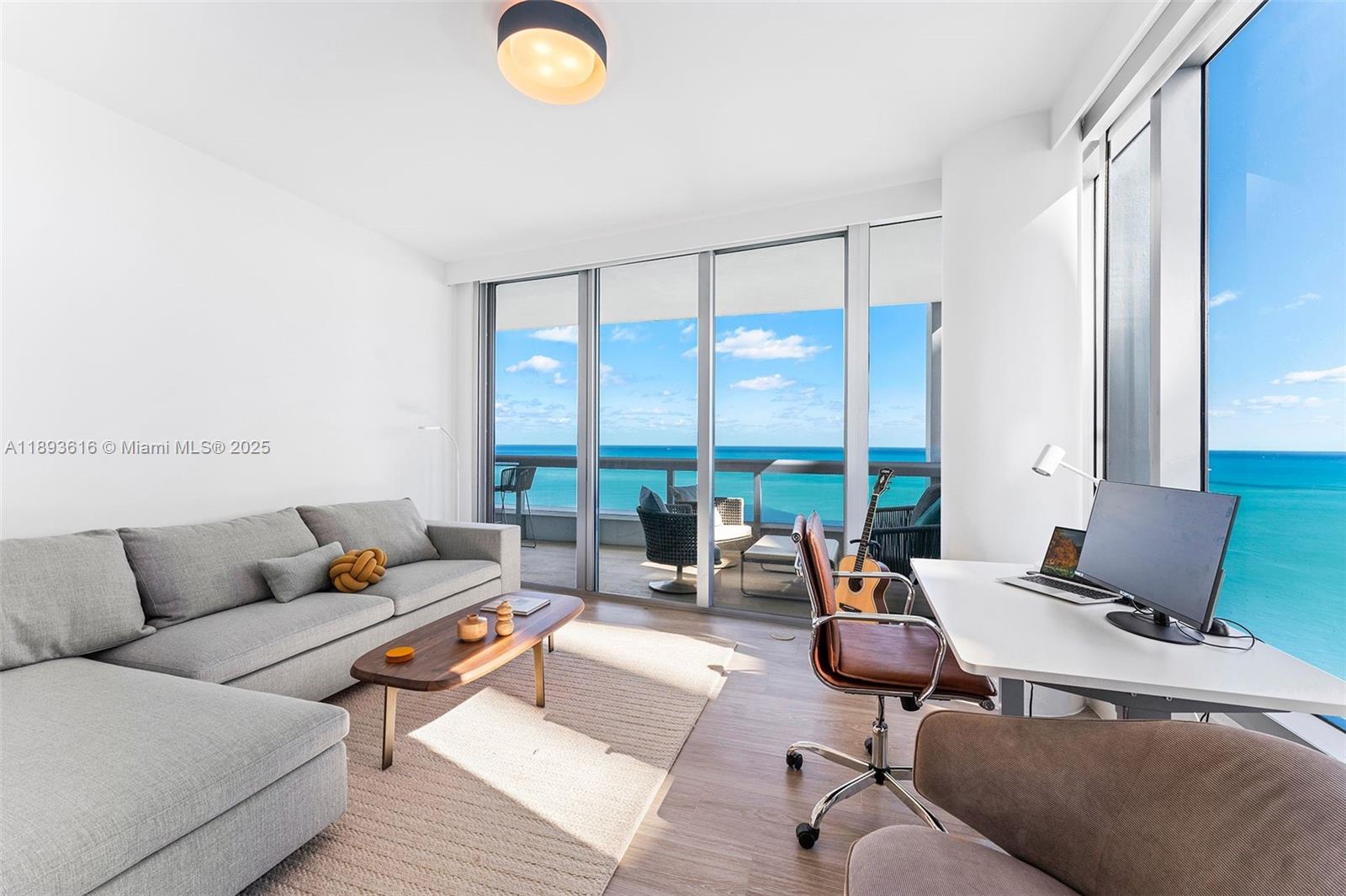 6899 Collins Avenue, Unit 2601 Miami Beach, FL 33141 - Photo 50 of 70 a living room with furniture and floor to ceiling windows