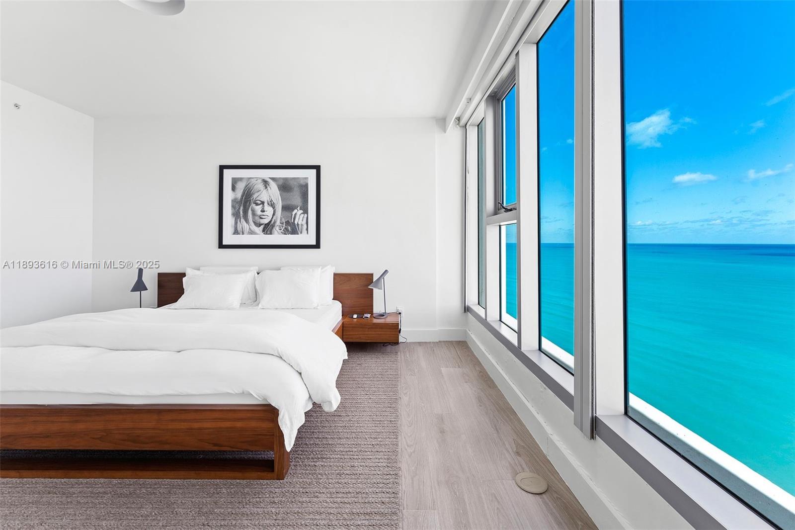 6899 Collins Avenue, Unit 2601 Miami Beach, FL 33141 - Photo 5 of 70 a bedroom with a bed and a large window with outer view