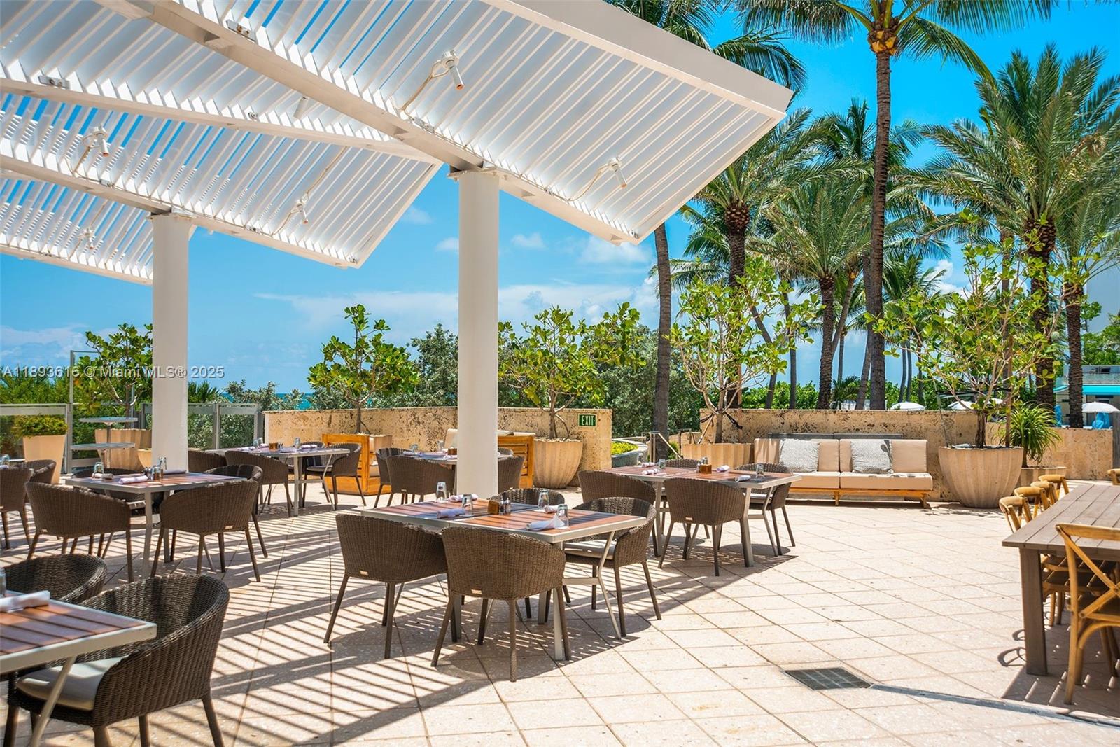 6899 Collins Avenue, Unit 2601 Miami Beach, FL 33141 - Photo 66 of 70 a view of patio with a table and chairs and potted plants