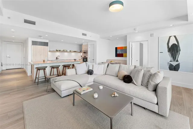 a bedroom with a bed and a view of living room