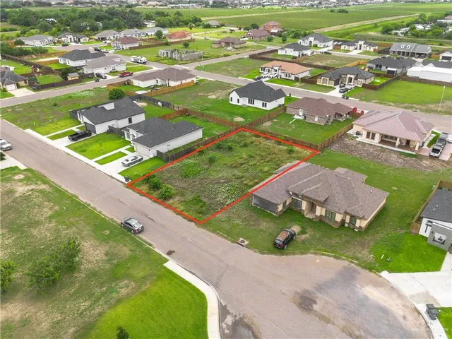 an aerial view of residential houses with outdoor space and river