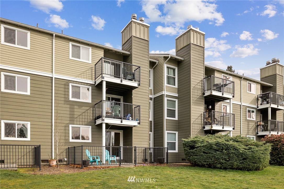 820 Cady Road, Unit G107 Everett, WA 98203 - Photo 1 of 1 a front view of a residential apartment building with a yard