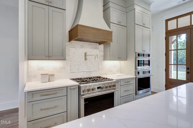 a bedroom with a bed couch and windows