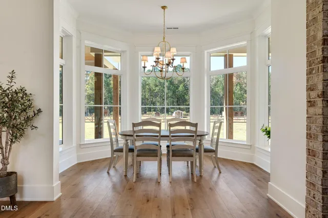 a spacious bathroom with a double vanity sink mirror and bathtub