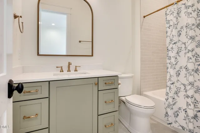 a view of an empty room with a fireplace and windows