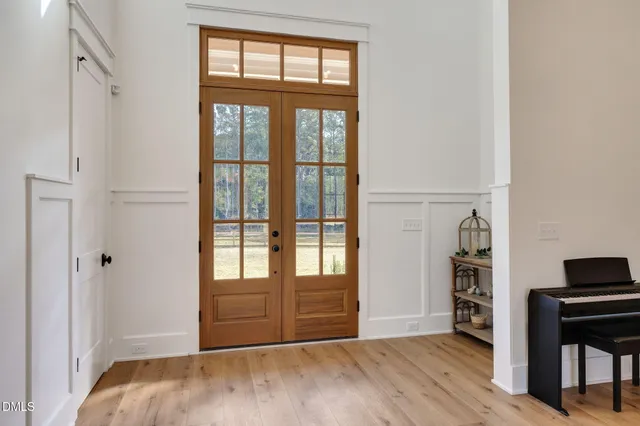 a view of a livingroom with wooden floor and a window