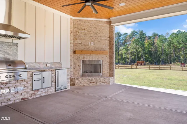 an aerial view of a house with a yard and lake view