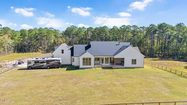 a backyard of a house with a yard and outdoor seating