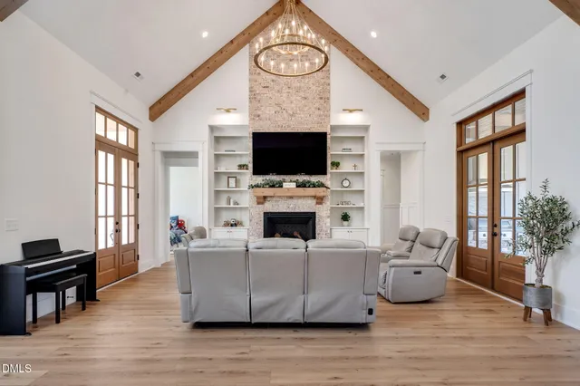 a living room with furniture a flat screen tv and a fireplace