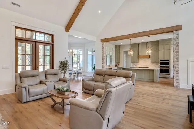 a large kitchen with kitchen island a sink stainless steel appliances and cabinets