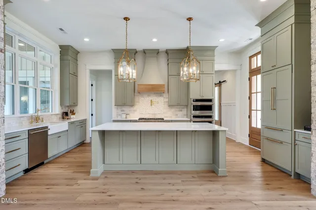 a kitchen with stainless steel appliances a stove and a microwave