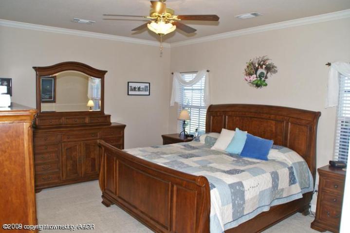 9320 Greyhawk Road Amarillo, TX 79119 - Photo 11 of 21 a bedroom with a bed and a dresser