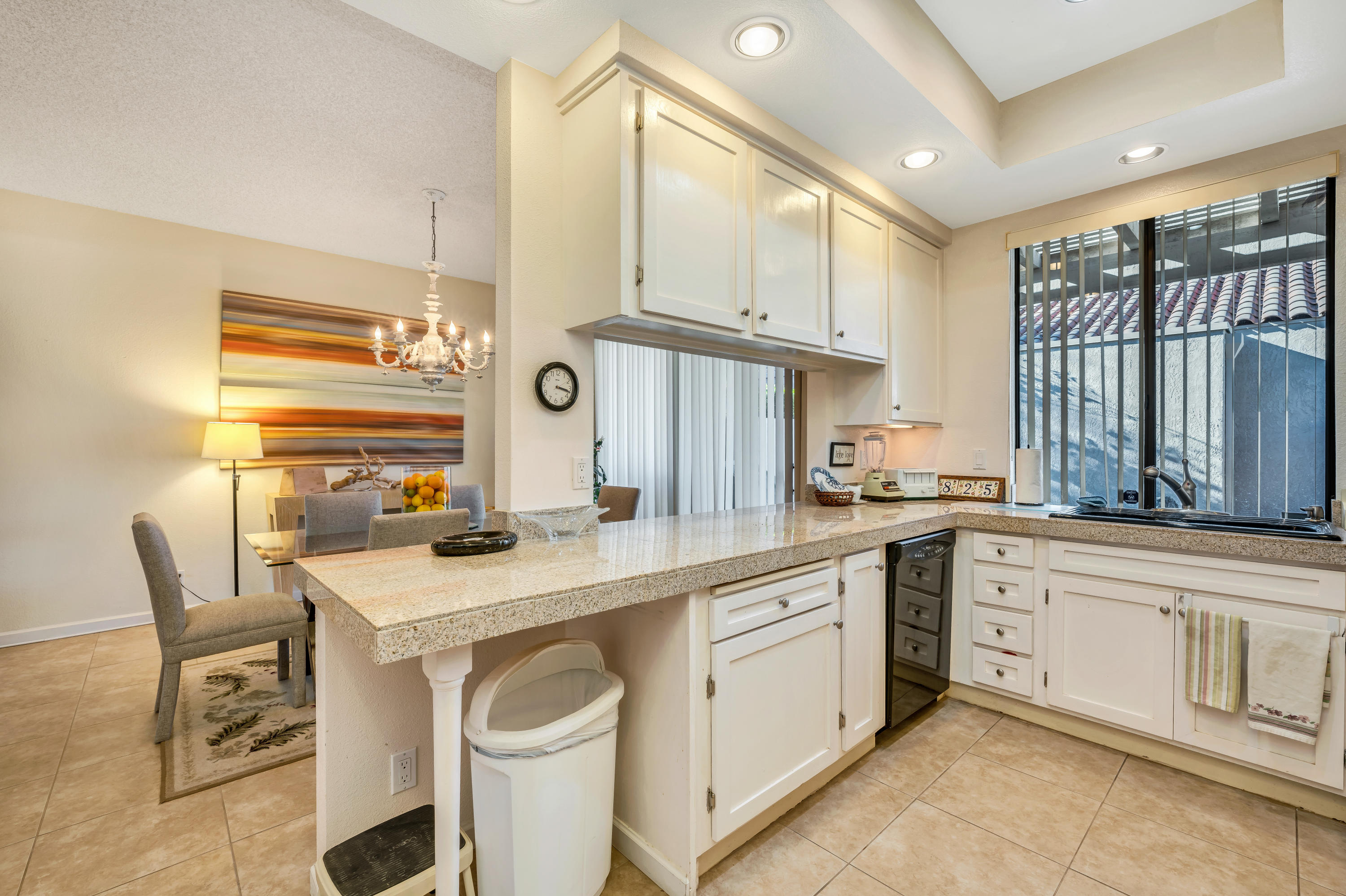 825 Inverness Drive Rancho Mirage, CA 92270 - Photo 11 of 34 a kitchen with a sink stove and cabinets