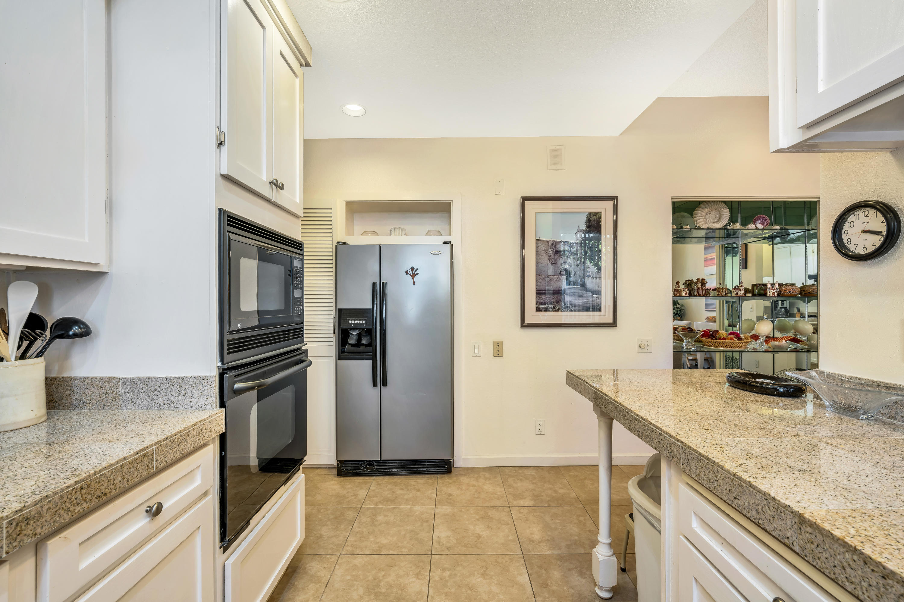 825 Inverness Drive Rancho Mirage, CA 92270 - Photo 12 of 34 a kitchen with granite countertop a refrigerator and stove