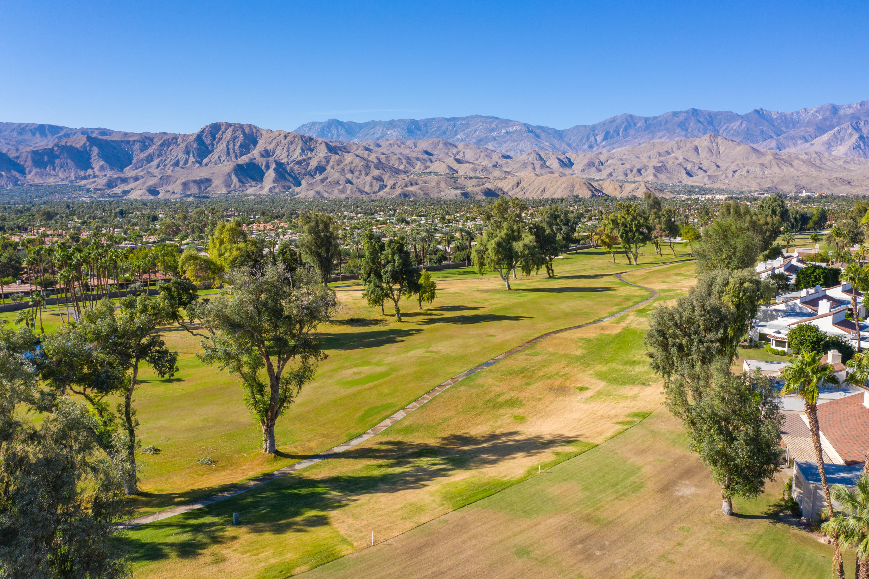 825 Inverness Drive Rancho Mirage, CA 92270 - Photo 16 of 34 a view of a swimming pool with mountains in the background