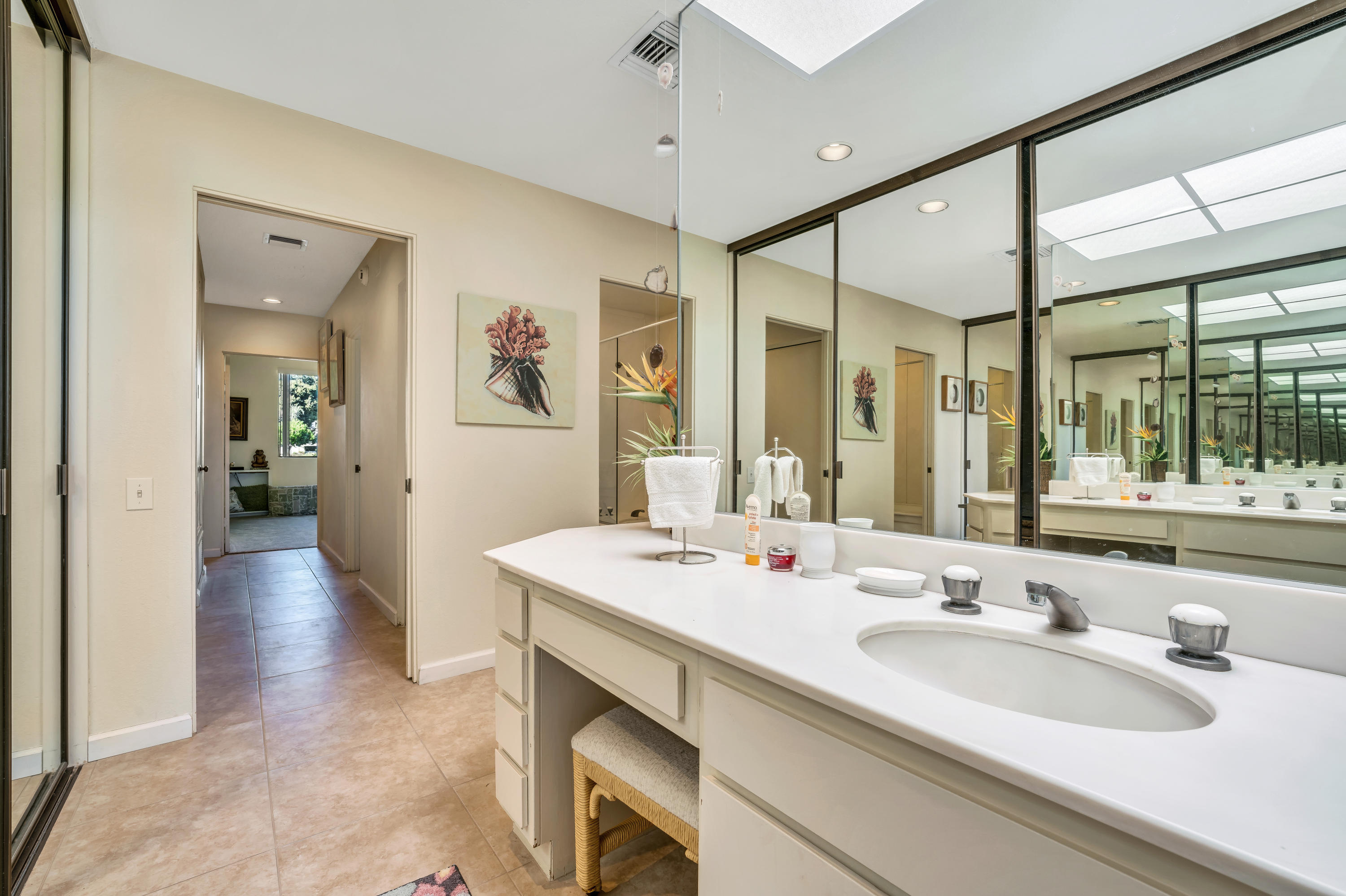 825 Inverness Drive Rancho Mirage, CA 92270 - Photo 21 of 34 a spacious bathroom with a sink a large mirror and a shower