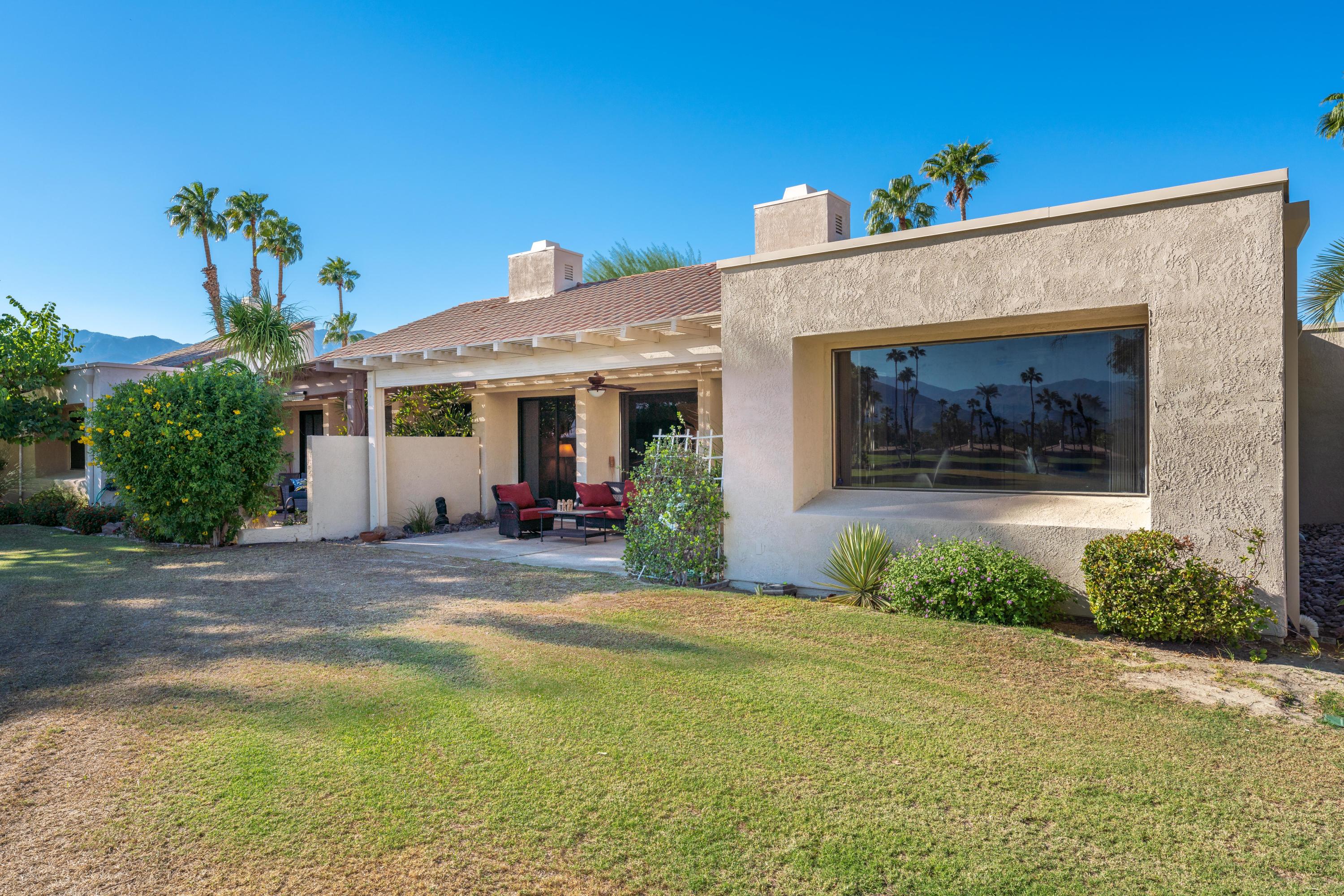 825 Inverness Drive Rancho Mirage, CA 92270 - Photo 23 of 34 a view of a house with potted plants and a yard