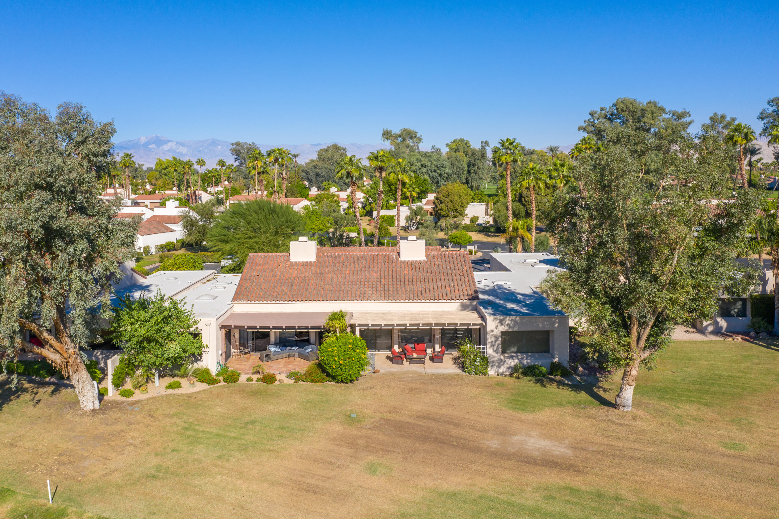 825 Inverness Drive Rancho Mirage, CA 92270 - Photo 25 of 34 a front view of a house with a yard and garage