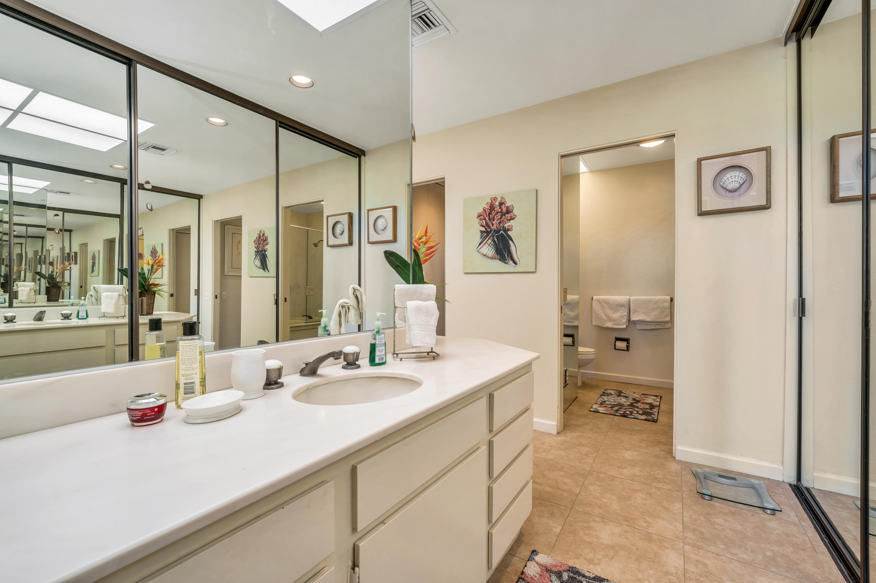 825 Inverness Drive Rancho Mirage, CA 92270 - Photo 30 of 34 a spacious bathroom with a sink a mirror a bathtub and shower
