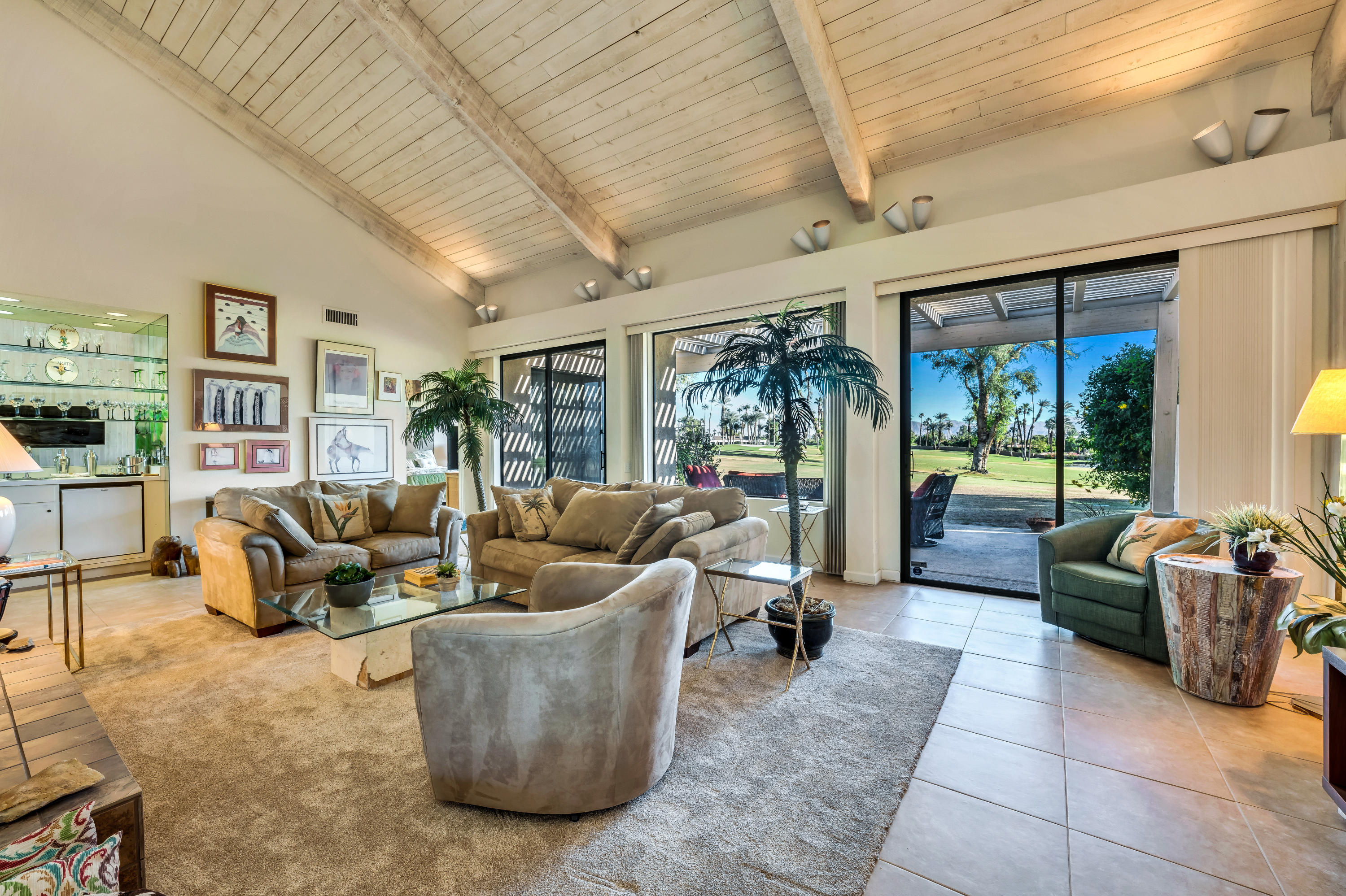 825 Inverness Drive Rancho Mirage, CA 92270 - Photo 7 of 34 a living room with furniture potted plant and large windows