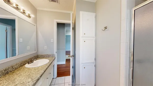 a bathroom with a granite countertop tub and double sink
