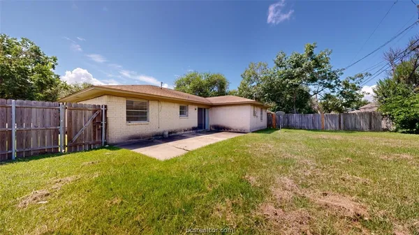 a front view of a house with a garden and garage
