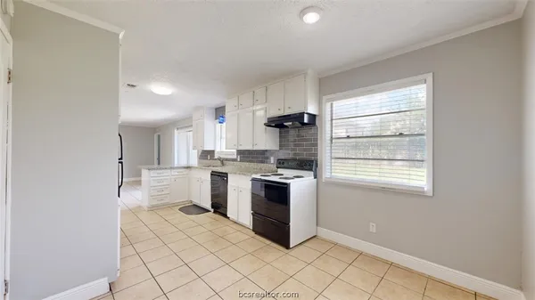 a kitchen with a stove a sink and a refrigerator