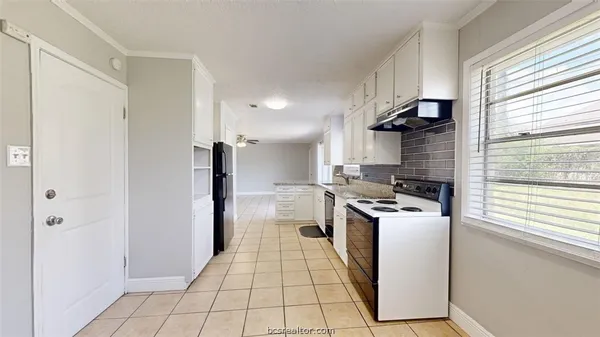 a kitchen with a stove a refrigerator and a sink