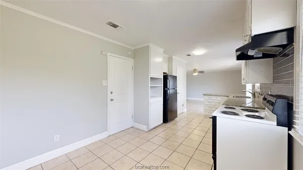 a kitchen with stainless steel appliances kitchen island a refrigerator sink and stove
