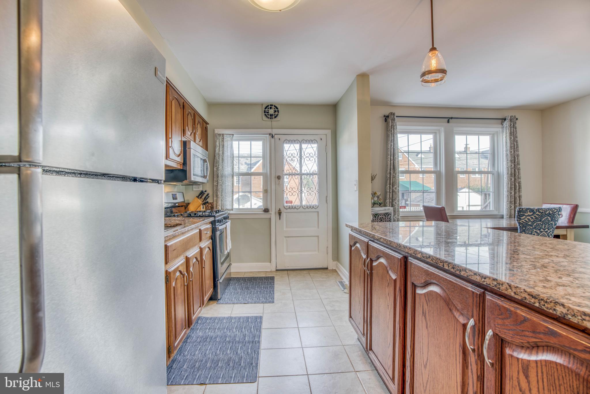 130 Hopkins Road Baltimore, MD 21212 - Photo 21 of 52 a kitchen with granite countertop a refrigerator a sink and dishwasher