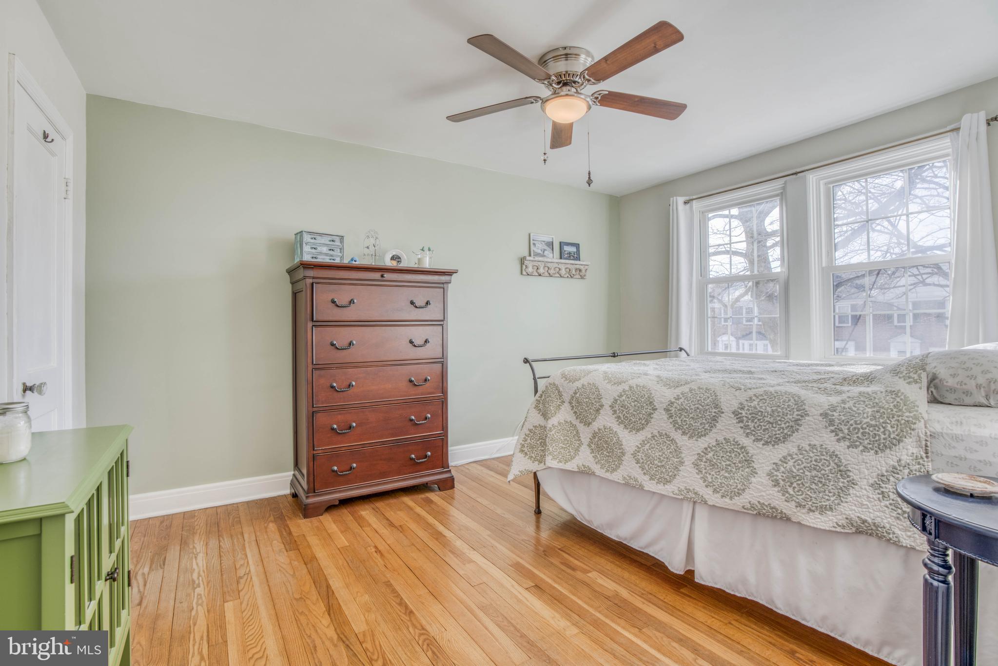 130 Hopkins Road Baltimore, MD 21212 - Photo 25 of 52 a spacious bedroom with a bed and a wooden floor