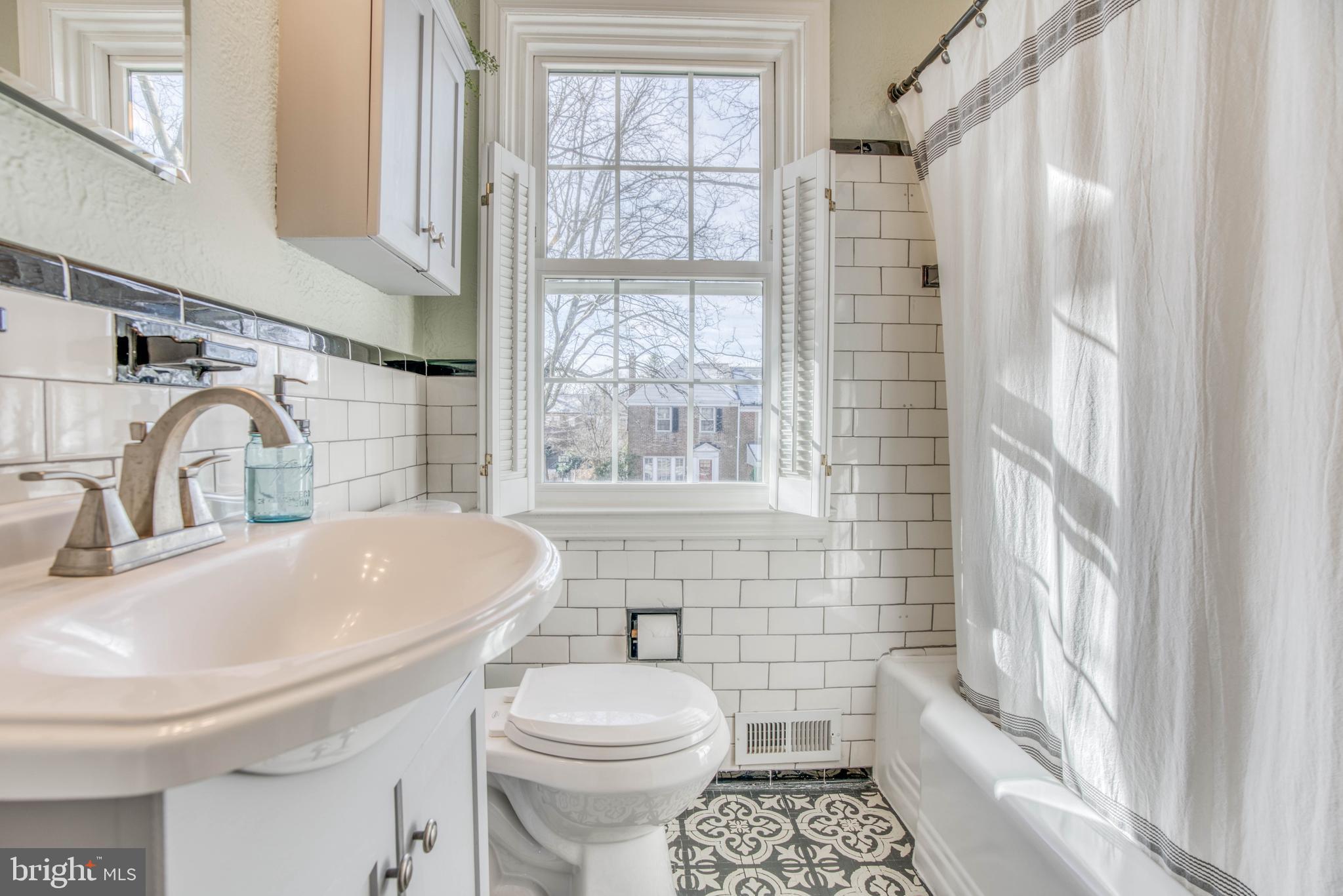 130 Hopkins Road Baltimore, MD 21212 - Photo 33 of 52 a bathroom with a sink a toilet and shower
