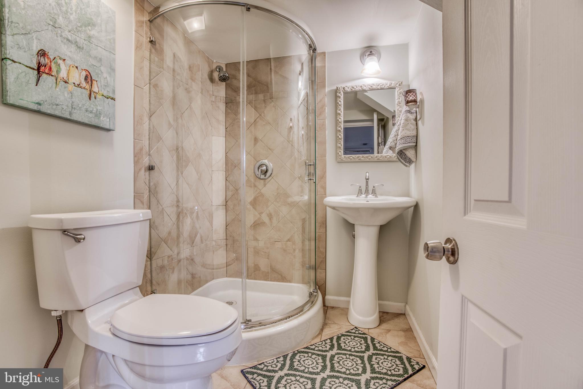 130 Hopkins Road Baltimore, MD 21212 - Photo 42 of 52 a bathroom with a sink toilet and shower