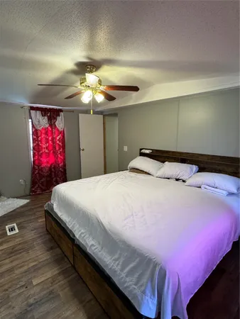 a bedroom with a bed and a chandelier