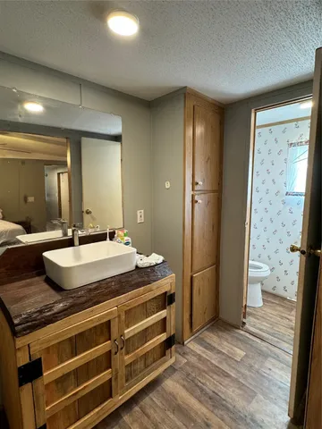 a bathroom with a granite countertop sink and a large mirror
