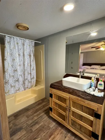 a bathroom with a sink a mirror and a bathtub