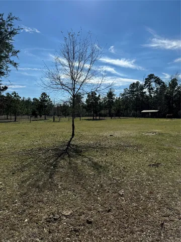 a view of outdoor space with deck and yard