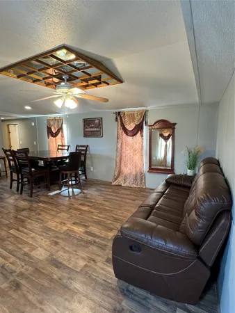 a living room with furniture and a dining table