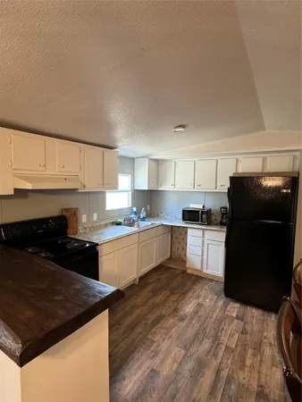 a kitchen with a stove a refrigerator and a sink