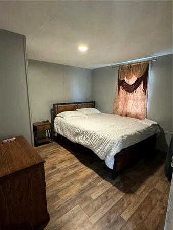 a bedroom with a bed and a night stand