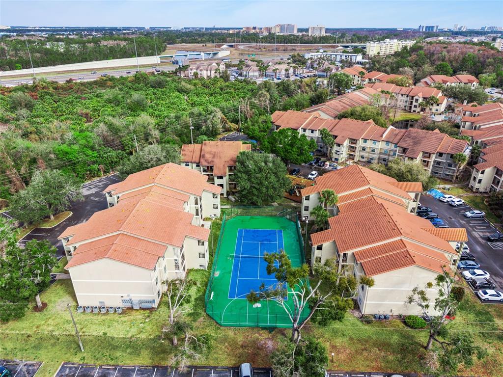3032 Parkway Boulevard, Unit 305 Kissimmee, FL 34747 - Photo 33 of 40 an aerial view of residential houses with outdoor space and trees